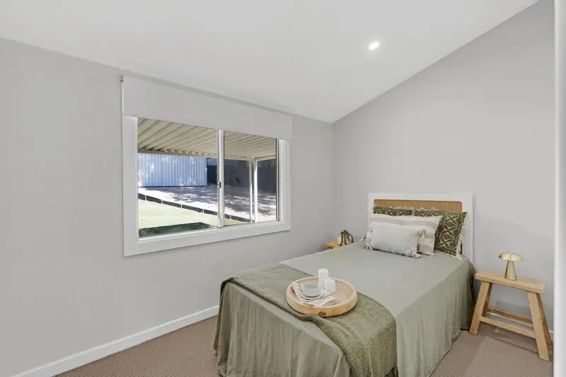 Renovated bedroom with new window, carpet and paint