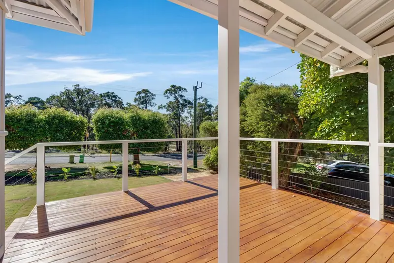 New timber front deck with white posts and wire balustrade
