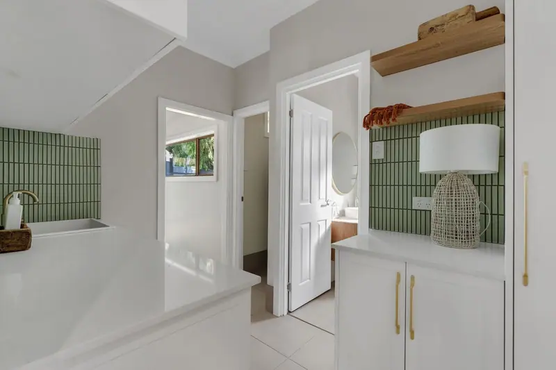 Laundry and hallway looking through to the renovated bathroom