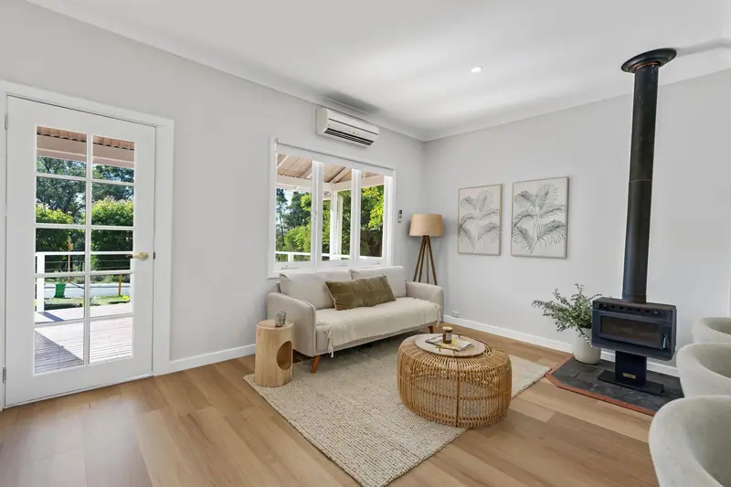 Living room with new French doors, timber flooring and fireplace