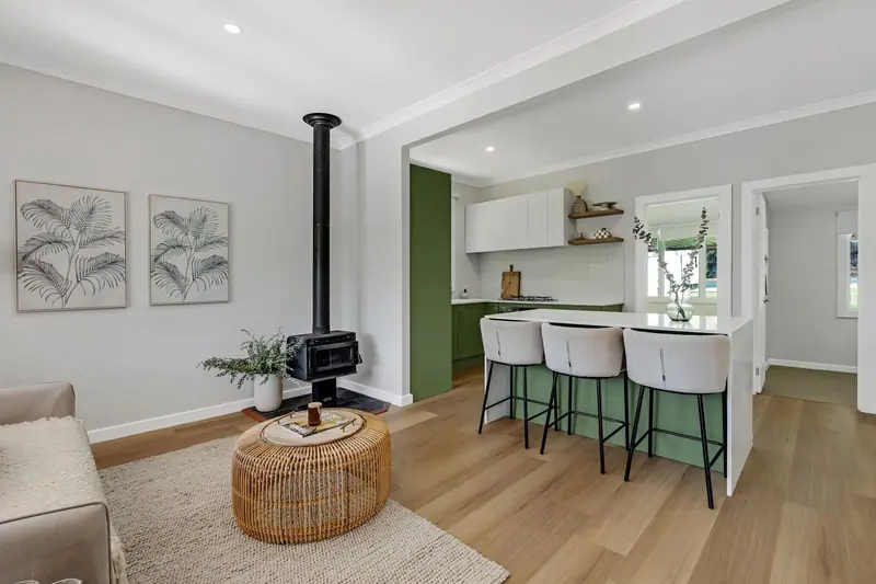 Open-plan living and kitchen with freestanding fireplace